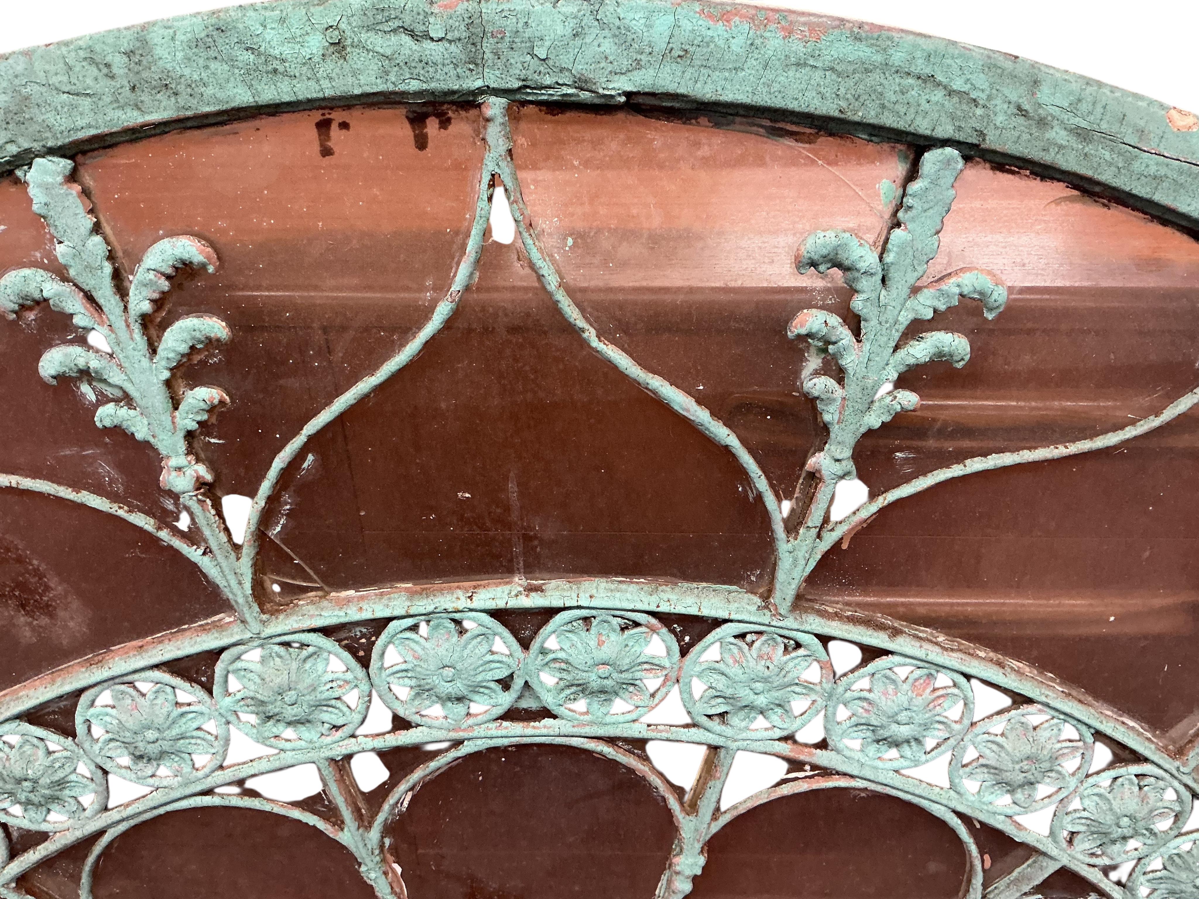 A 19th century wood and wrought iron fan light, later painted, width 170cm, height 91cm
